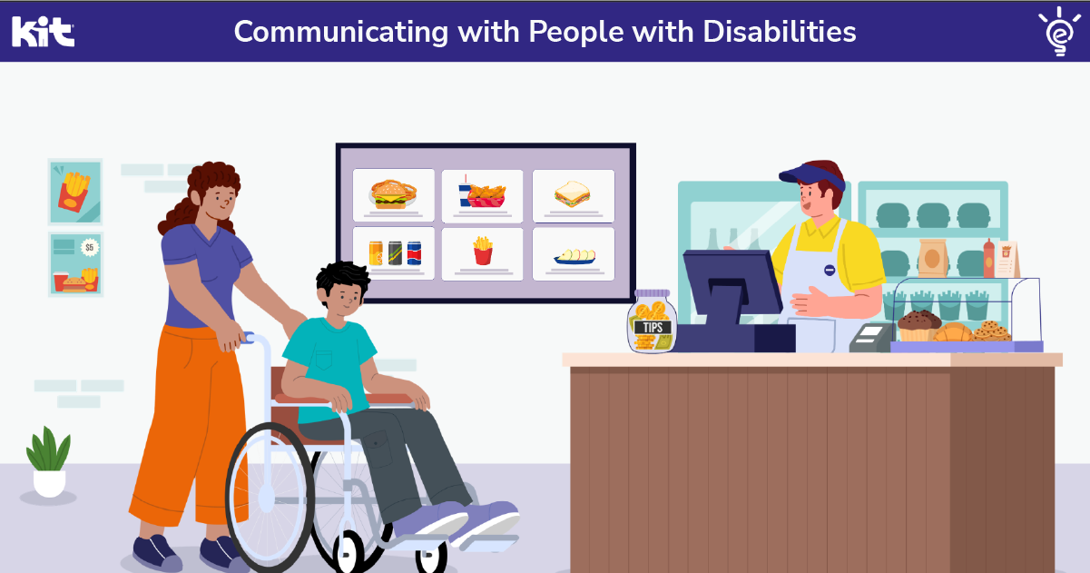 A customer using a wheelchair orders at a fast food counter while a staff member points to the picture menu